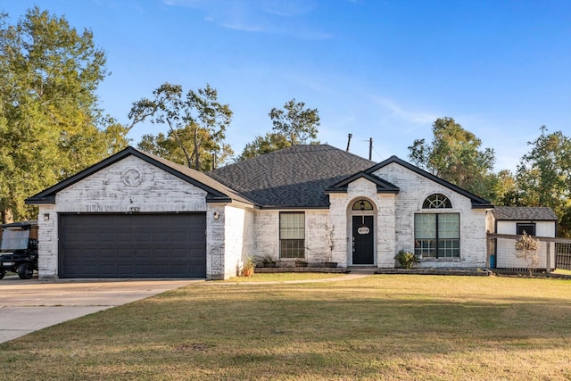 view of front of house with a front lawn and a garage