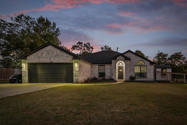 view of front facade featuring a yard and a garage