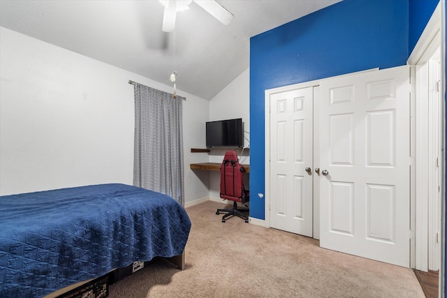 bedroom with carpet flooring, a closet, vaulted ceiling, and ceiling fan