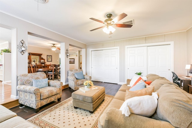 living room featuring ceiling fan, hardwood / wood-style floors, and ornamental molding