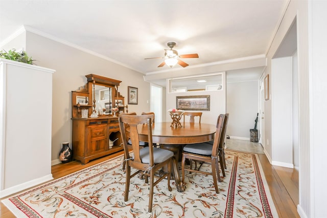 dining room with light hardwood / wood-style floors, ceiling fan, and crown molding