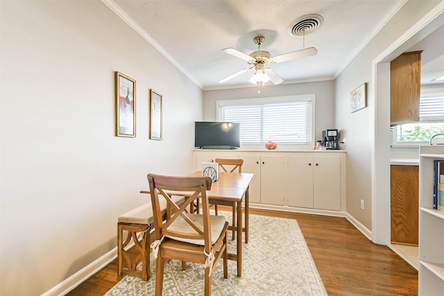 dining area featuring a wealth of natural light, hardwood / wood-style flooring, and ornamental molding