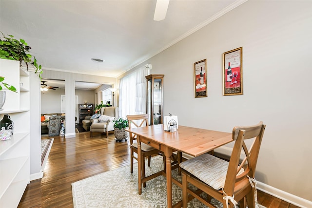 dining space featuring dark hardwood / wood-style flooring, ceiling fan, and ornamental molding