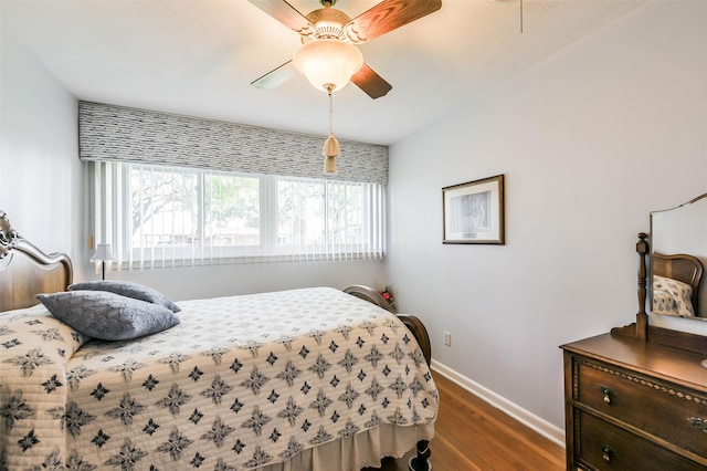 bedroom with dark hardwood / wood-style flooring and ceiling fan