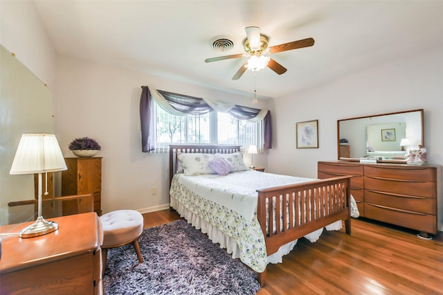 bedroom featuring ceiling fan and dark hardwood / wood-style floors