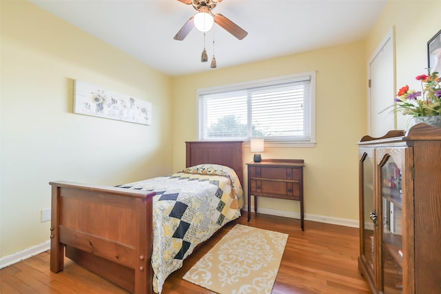 bedroom with hardwood / wood-style flooring and ceiling fan