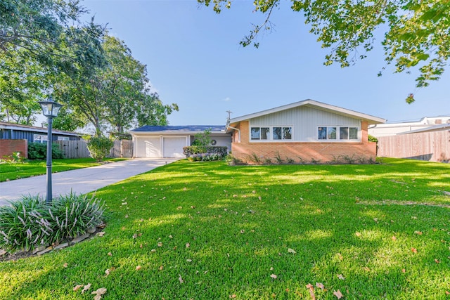 ranch-style home featuring a garage and a front lawn