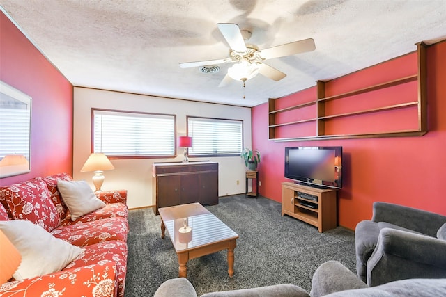 carpeted living room with ceiling fan and a textured ceiling