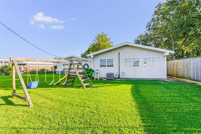 exterior space featuring a lawn, cooling unit, and a playground