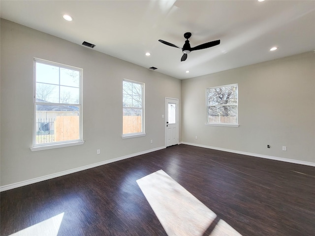 empty room featuring ceiling fan and dark wood-type flooring