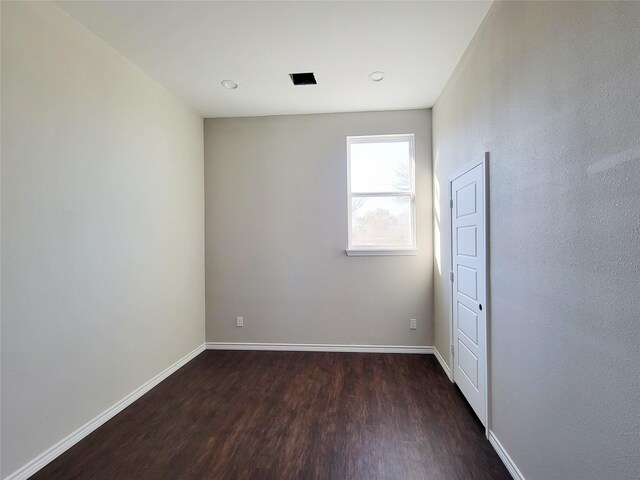 unfurnished room featuring dark wood-type flooring