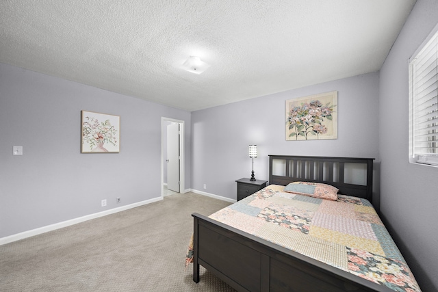 carpeted bedroom featuring a textured ceiling