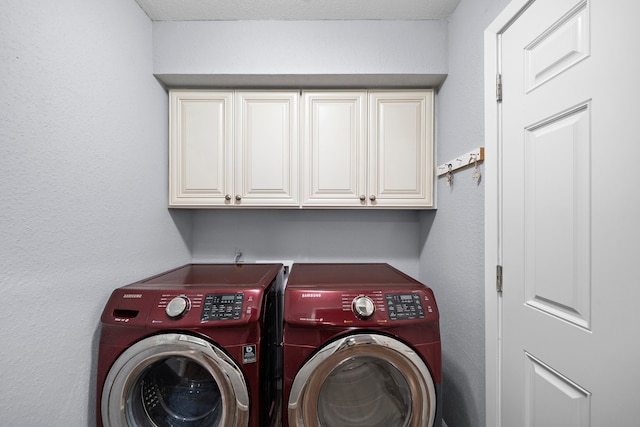 washroom with independent washer and dryer and cabinets