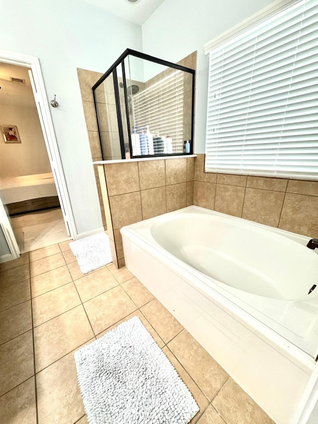 bathroom featuring shower with separate bathtub and tile patterned floors