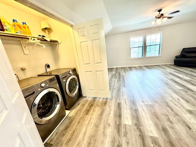 laundry room featuring ceiling fan, light wood-type flooring, and washing machine and clothes dryer