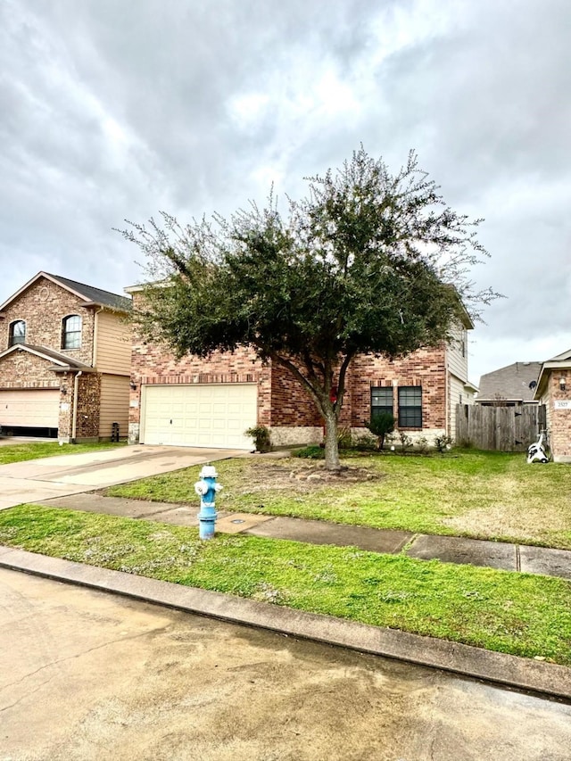 view of front of home with a front yard and a garage