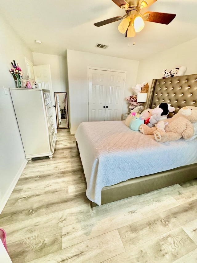 bedroom featuring light hardwood / wood-style flooring, a closet, and ceiling fan