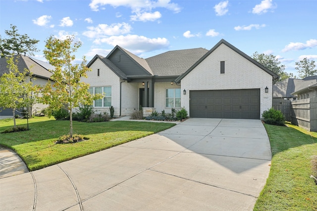 view of front of home with a front lawn and a garage