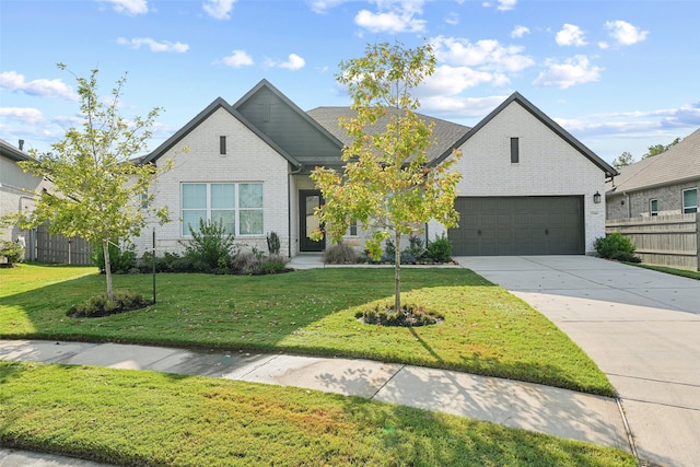 view of front of house featuring a front yard, brick siding, driveway, and fence