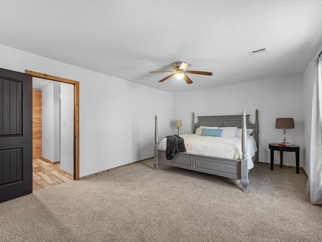 bedroom featuring ceiling fan and light colored carpet