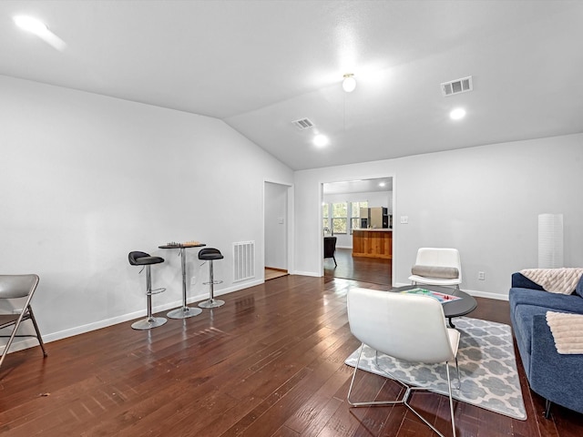 sitting room with dark wood-type flooring and lofted ceiling