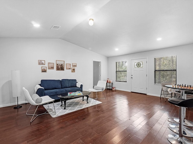 living room with dark hardwood / wood-style floors and lofted ceiling