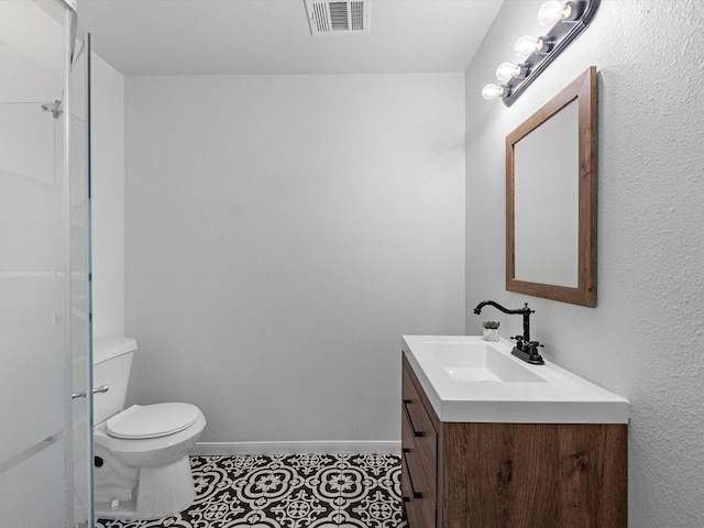 bathroom with tile patterned floors, vanity, and toilet