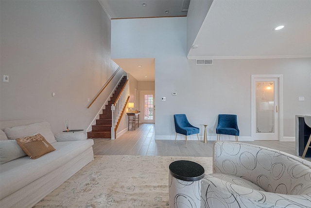 4 Rutgers Pl W, University Place, TX 77005 - living room featuring stairway, light wood-type flooring, crown molding, baseboards, and a high ceiling