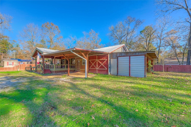 back of property with a lawn and an outbuilding