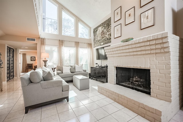 tiled living room featuring a fireplace and high vaulted ceiling