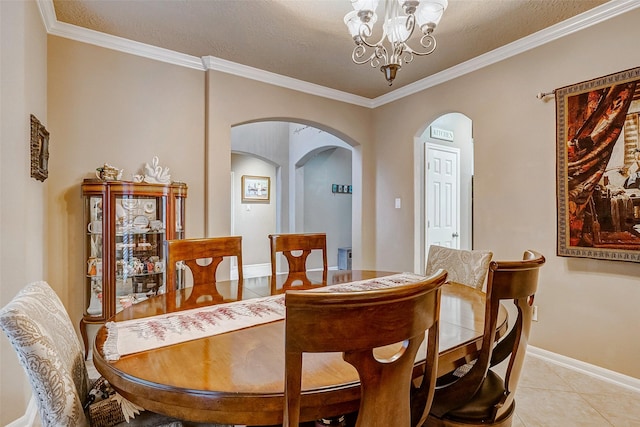 tiled dining area with a textured ceiling, an inviting chandelier, and crown molding