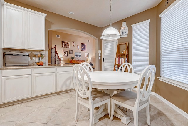 dining space featuring light tile patterned floors