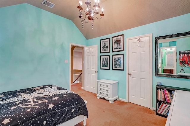 carpeted bedroom featuring a chandelier and lofted ceiling