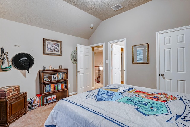 carpeted bedroom featuring lofted ceiling and a textured ceiling