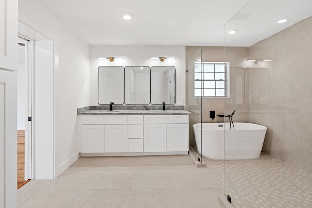 bathroom featuring tile patterned flooring, vanity, and shower with separate bathtub