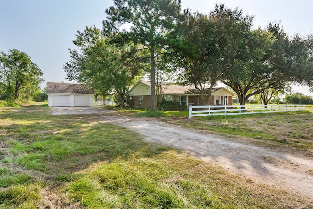 view of front of home with a garage and an outdoor structure