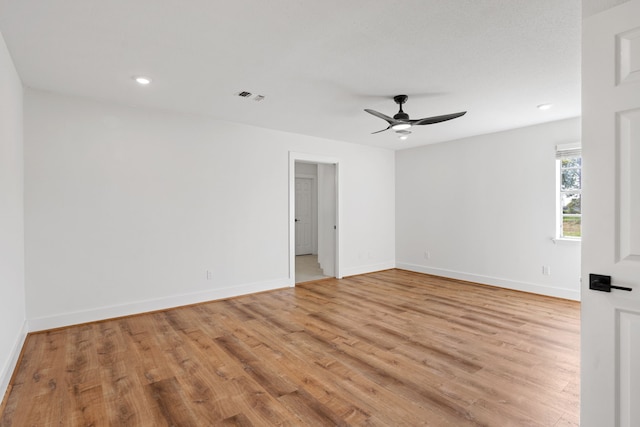 spare room featuring ceiling fan and light wood-type flooring