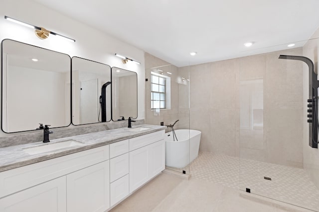 bathroom with tile patterned floors, vanity, separate shower and tub, and tile walls