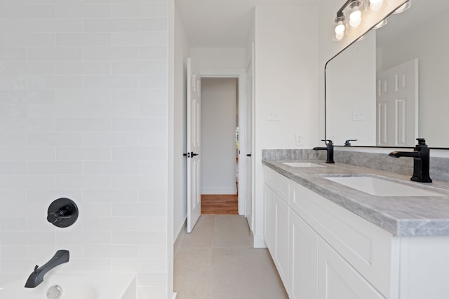 bathroom with tile patterned flooring, vanity, and washtub / shower combination