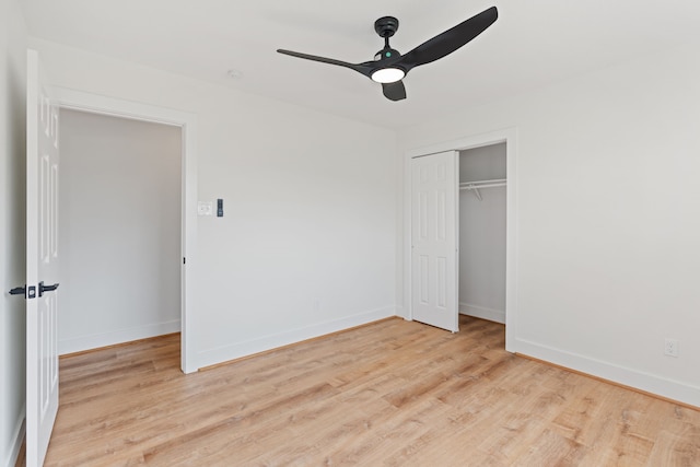 unfurnished bedroom featuring ceiling fan, light wood-type flooring, and a closet