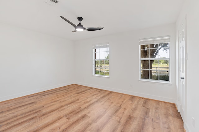 empty room featuring ceiling fan and light hardwood / wood-style floors