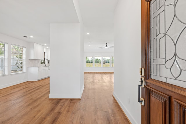 foyer entrance featuring plenty of natural light, light hardwood / wood-style floors, and ceiling fan