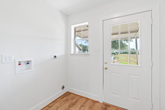 laundry room with electric dryer hookup, a wealth of natural light, washer hookup, and hardwood / wood-style flooring