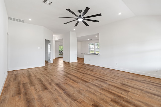 unfurnished living room featuring ceiling fan, hardwood / wood-style floors, and lofted ceiling