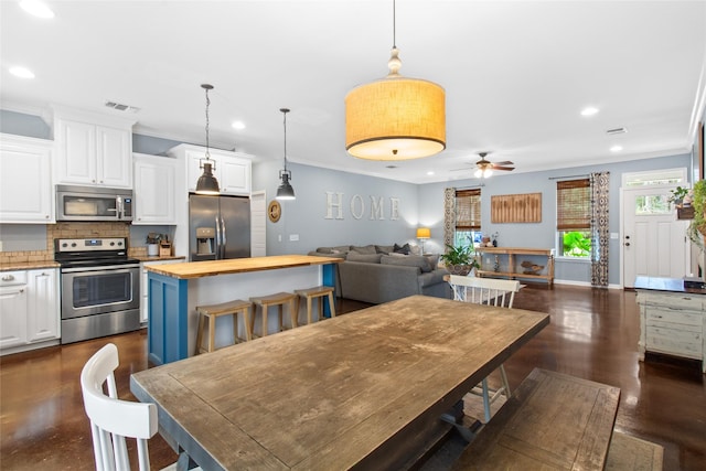 dining room featuring ornamental molding and ceiling fan