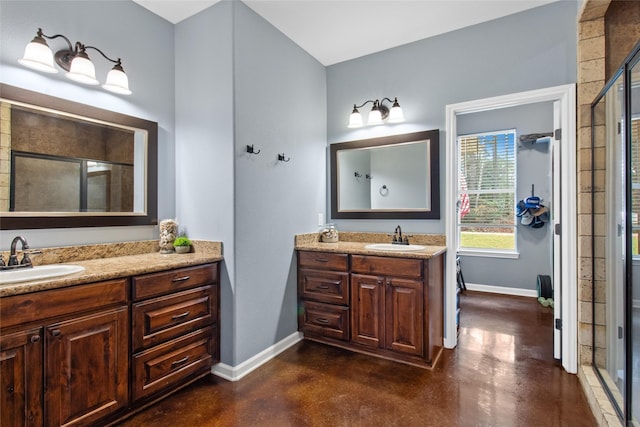 bathroom with a shower with door, concrete floors, and vanity