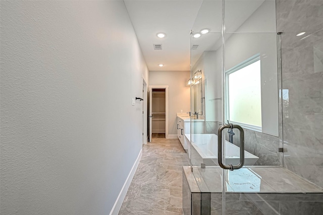 bathroom with vanity and a shower with door