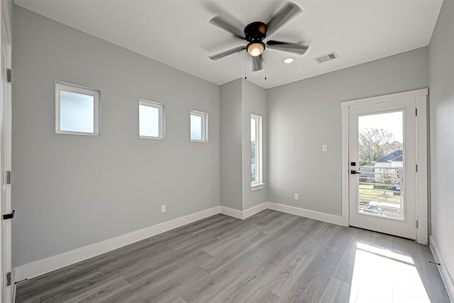 spare room with ceiling fan and light hardwood / wood-style flooring