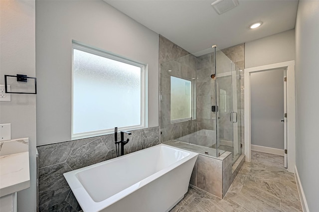 bathroom featuring plus walk in shower and vanity