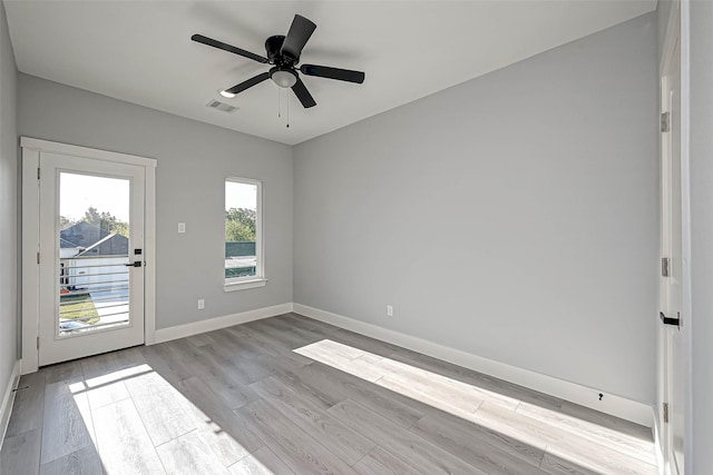 spare room with ceiling fan and light hardwood / wood-style floors